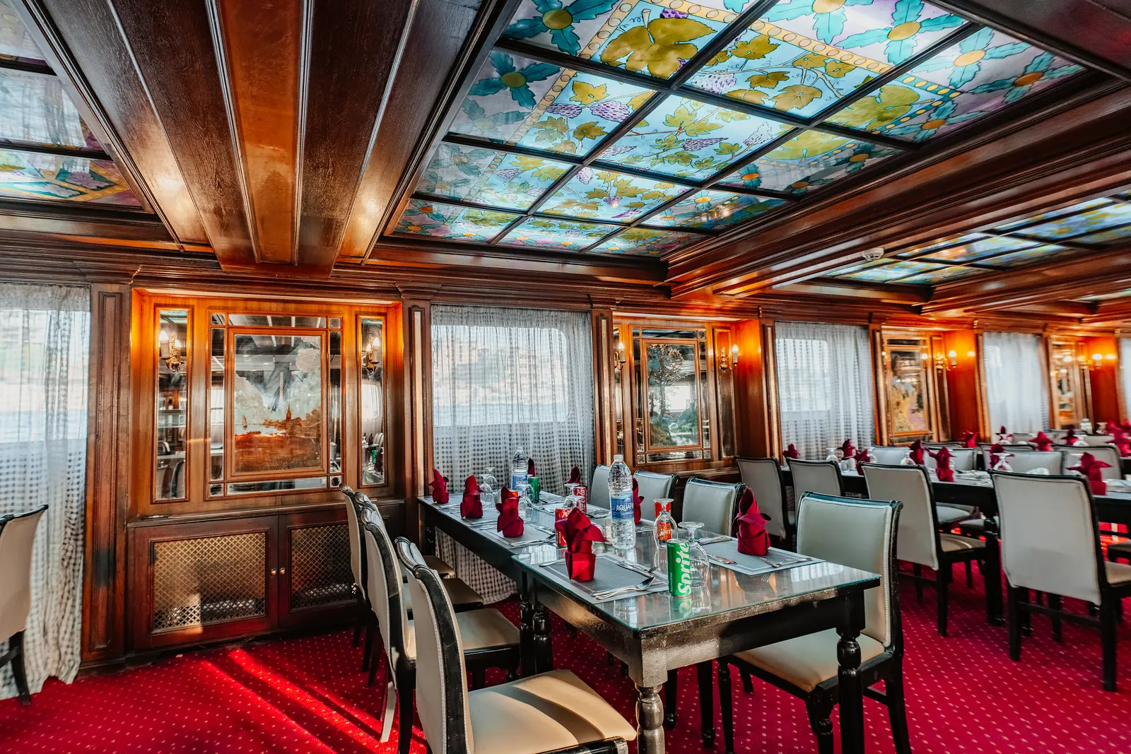 The dining room under its stained-glass ceiling